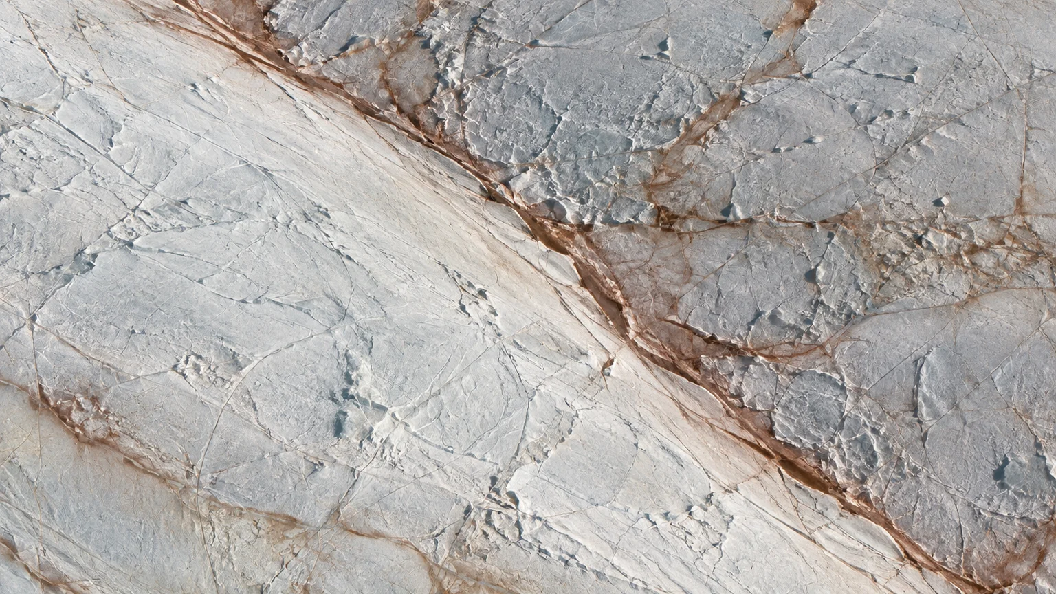 Two broad pale icy bands meeting diagonally with narrow rust-stained edges, fine cracked textures. An artistic reconstruction of Europa; local detail, lighting and viewpoint are imagined.