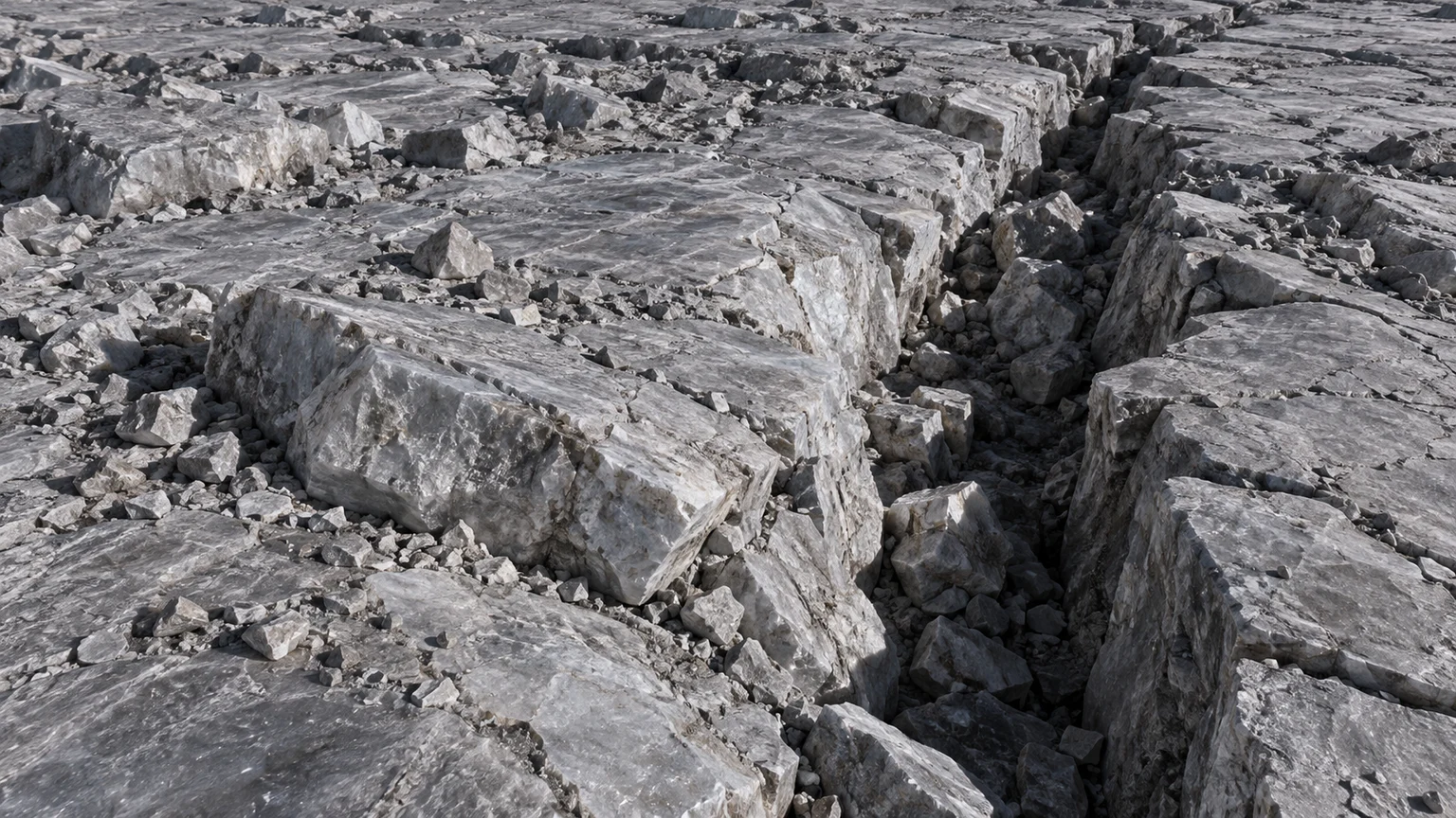Fragmented gray ice-rich slabs beside a narrow shadowed fault line. An artistic reconstruction of Titania; local detail, lighting and viewpoint are imagined.